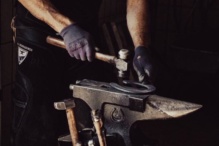 A blacksmith forging a horseshoe at a forge