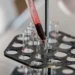 Liquid being transferred into test tubes in a laboratory